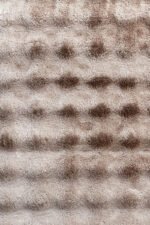 Detailed view of the plush pile of a beige shaggy rug 4x6 ft