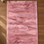 Pink shaggy rug displayed in a modern living room