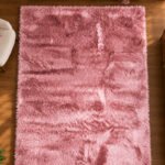 Pink shaggy rug displayed in a modern living room