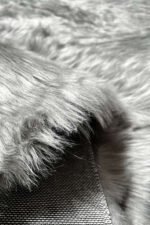 Close-up of the fluffy texture of a grey shaggy rug