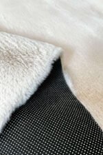 Close-up of the soft fluffy texture of a Ivory shaggy rug