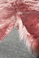 Close-up of the fluffy texture of a pink shaggy rug