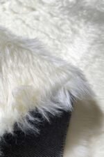 Close-up of the fluffy texture of a white shaggy rug
