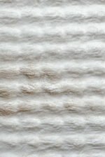 Close-up of the fluffy texture of a white shaggy rug