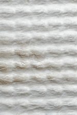 Close-up of the fluffy texture of a white shaggy rug