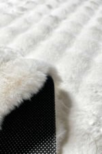 Close-up of the fluffy texture of a white shaggy rug